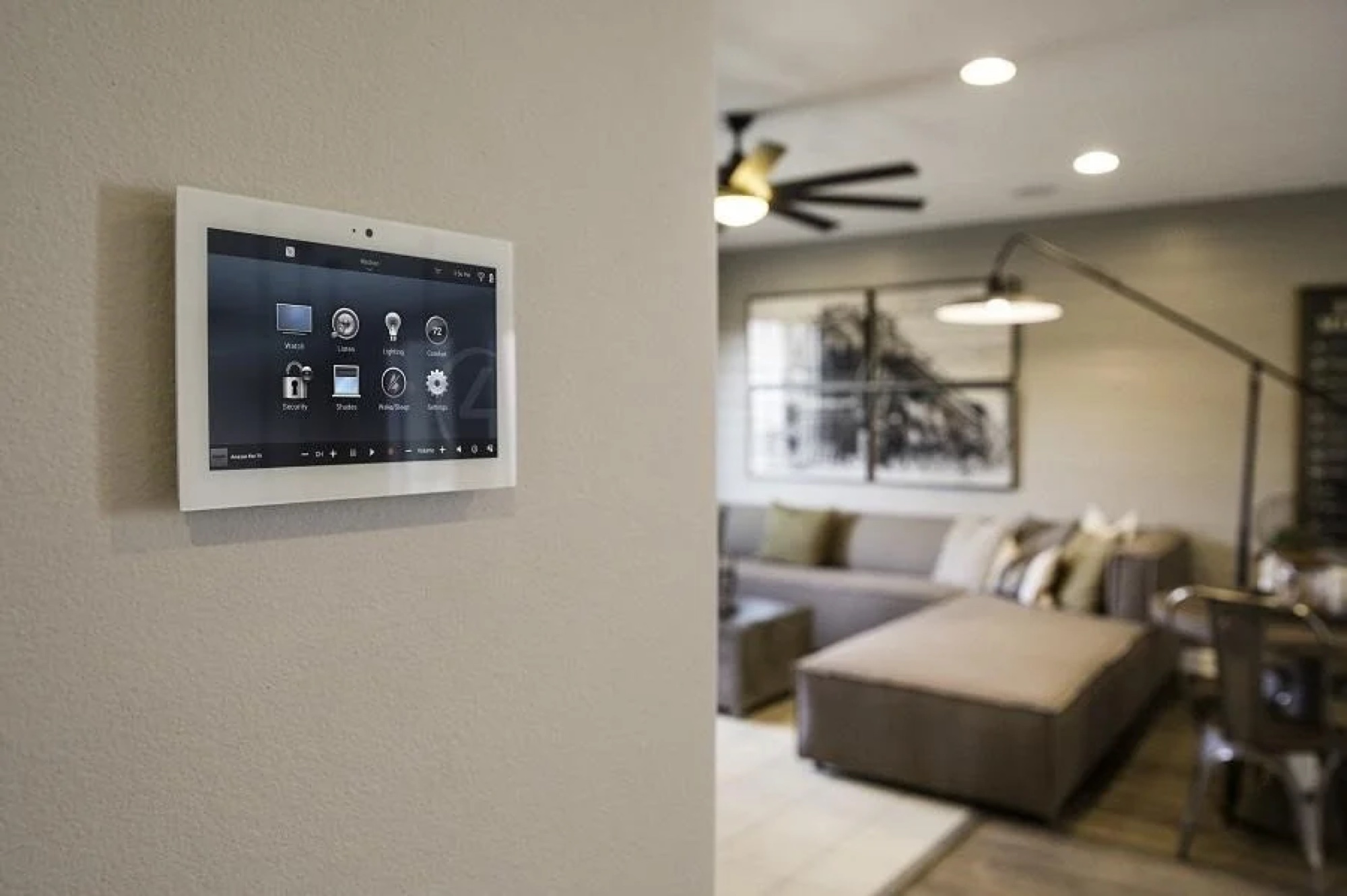Wall-mounted Control4 touchscreen controlling lighting, shades, security and comfort